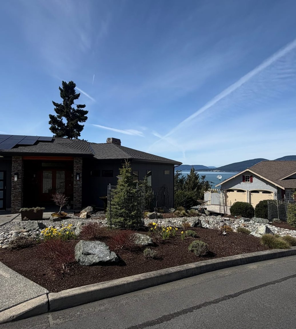 Maintained front yard planting beds by C & C Landscape